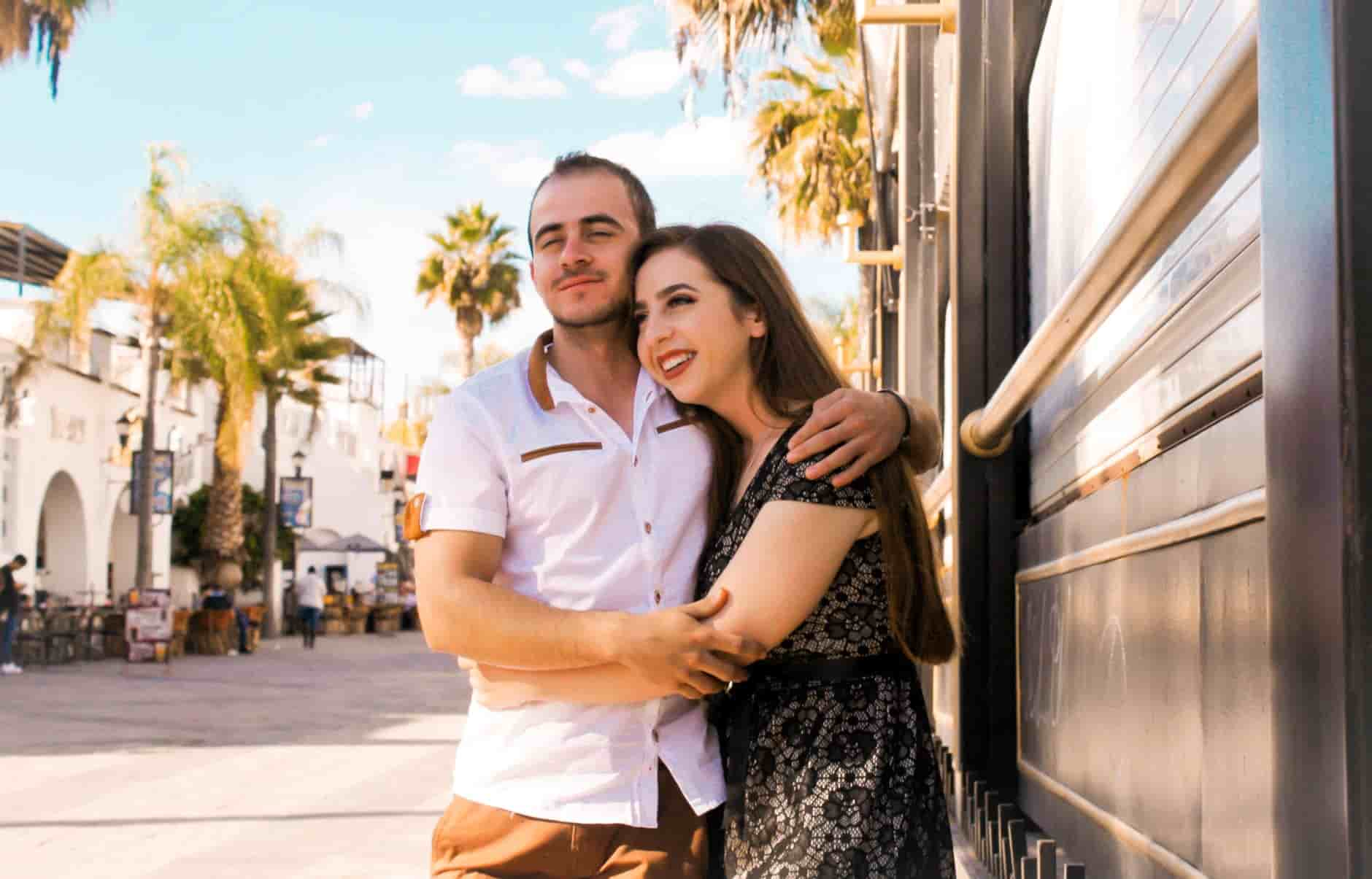 A photo of a man and Latina woman hugging each other